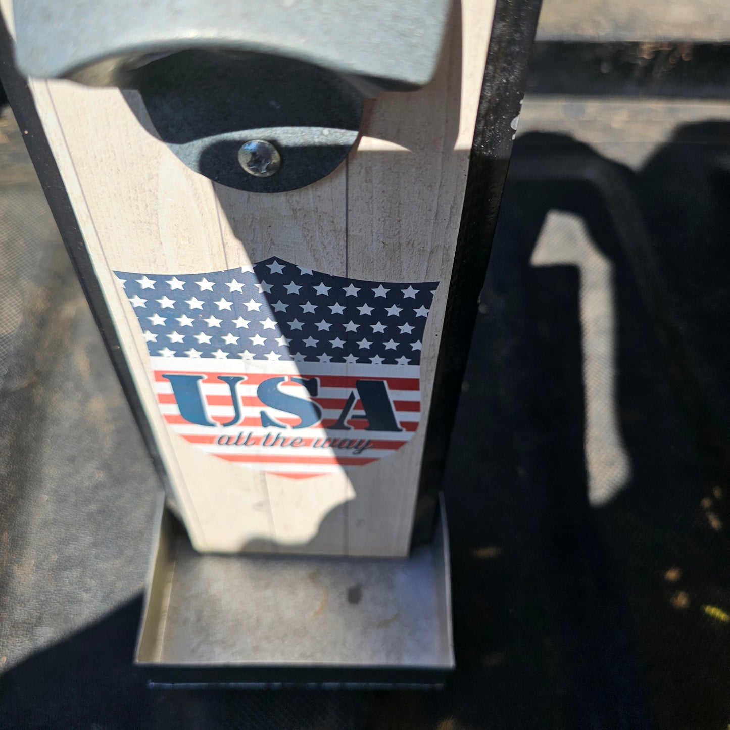 Wall-mounted bottle opener with a cap catcher