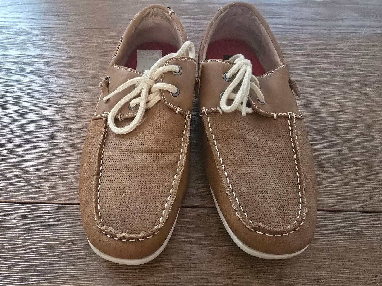 Brown men’s boat shoes with white stitching and lace-up design size 9
