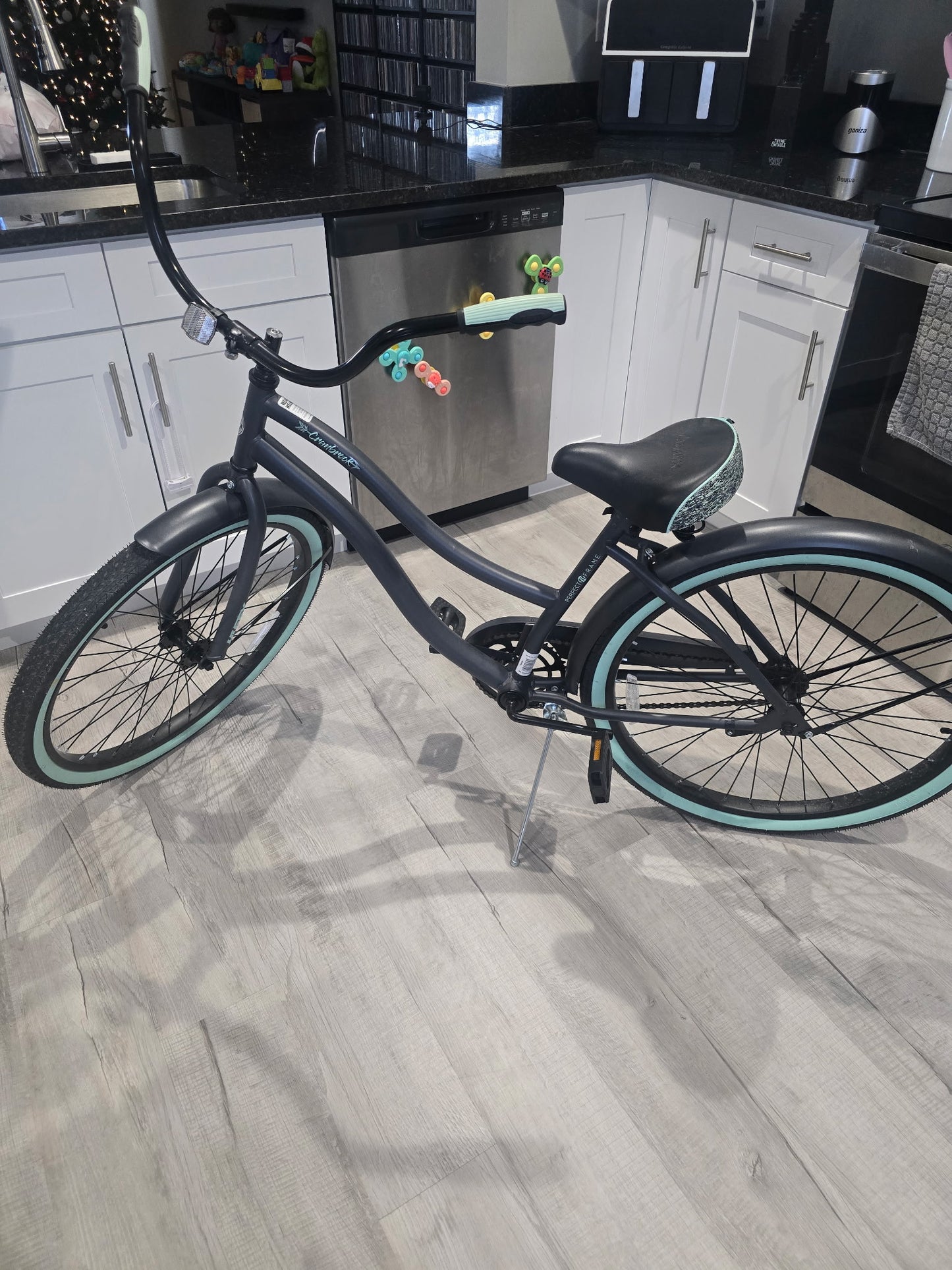 Huffy 26-inch Cranbrook comfort cruiser bike in gray with mint green accents.